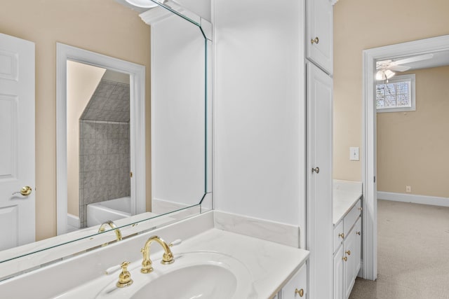 full bath featuring baseboards and vanity