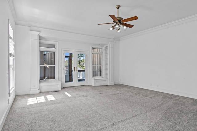 empty room featuring ornamental molding, french doors, carpet, and baseboards