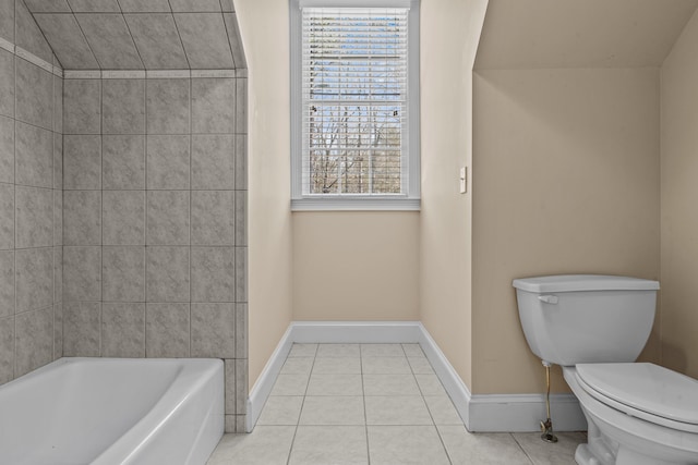 full bathroom featuring toilet, baseboards, a bath, and tile patterned floors