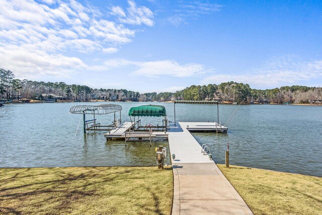 dock area with a water view and a lawn