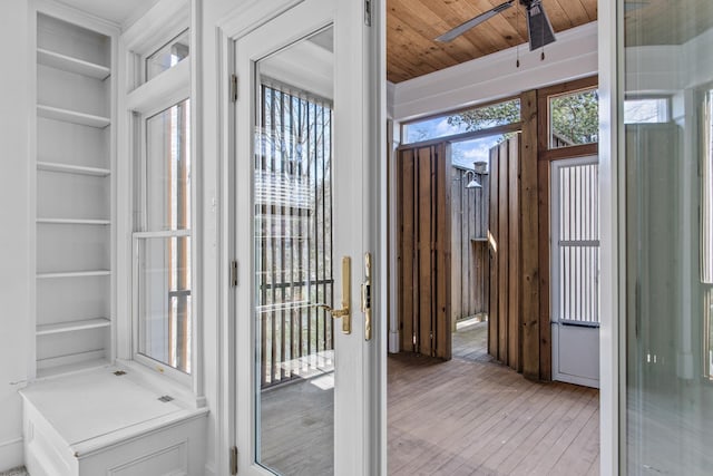 entryway featuring built in shelves, wooden ceiling, ceiling fan, and light wood-style flooring