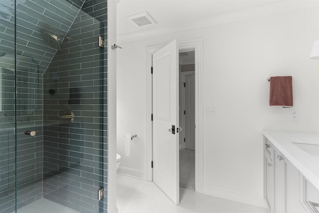 bathroom featuring vanity, a shower with door, tile patterned floors, and toilet