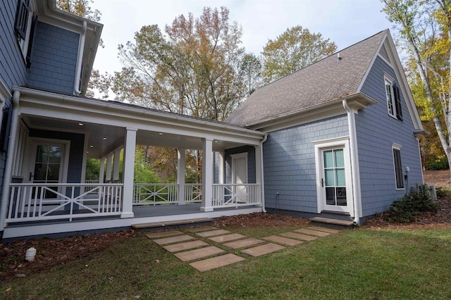 back of house with a porch and a yard