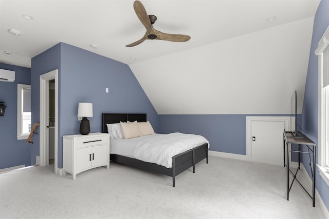 bedroom featuring vaulted ceiling, an AC wall unit, light carpet, and ceiling fan