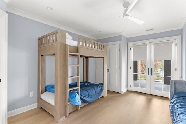 bedroom with crown molding, ceiling fan, access to exterior, hardwood / wood-style floors, and french doors