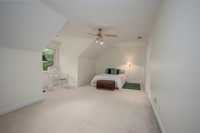 bedroom featuring ceiling fan, vaulted ceiling, and light carpet