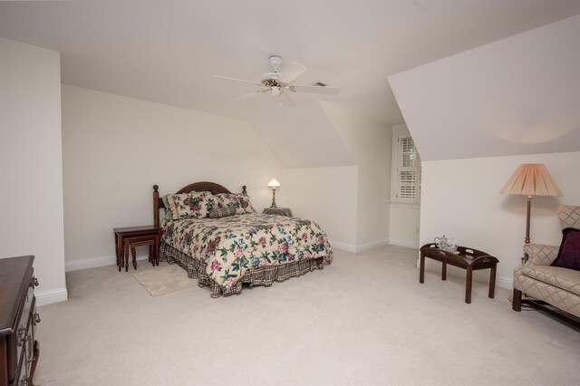 bedroom with ceiling fan, lofted ceiling, and light carpet