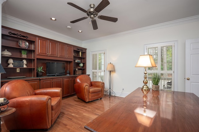 living room featuring ornamental molding, ceiling fan, and light wood-type flooring