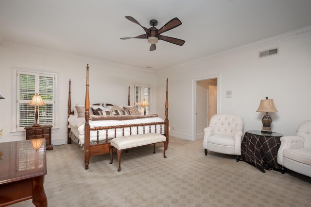 bedroom featuring ornamental molding, light carpet, and ceiling fan