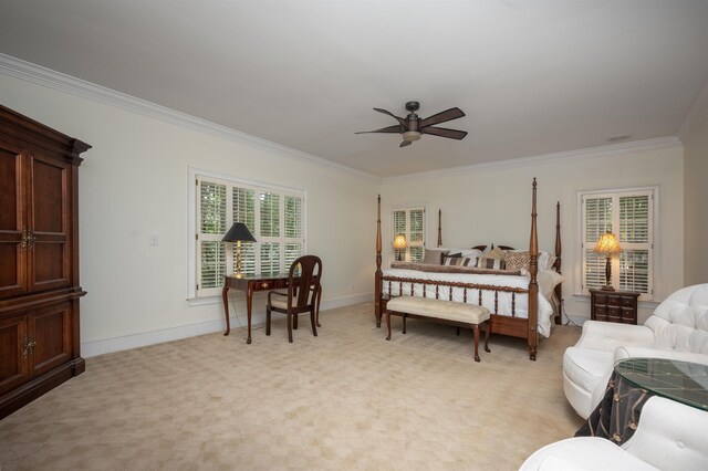 carpeted bedroom with ornamental molding and ceiling fan