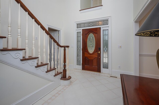 tiled entrance foyer with a high ceiling