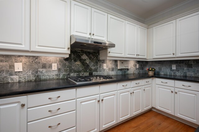 kitchen featuring stainless steel gas stovetop, white cabinetry, and hardwood / wood-style flooring