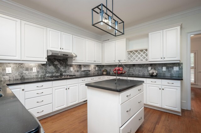 kitchen with stainless steel gas stovetop, white cabinets, and decorative light fixtures