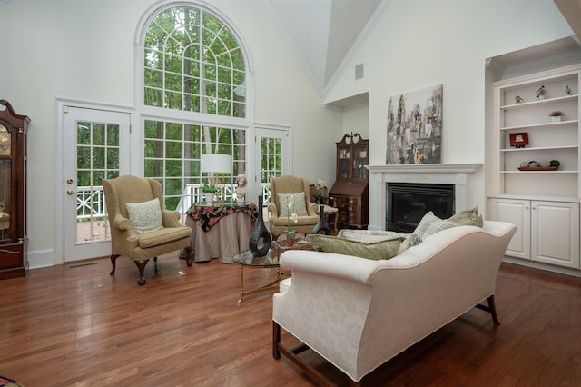 living room with ornamental molding, high vaulted ceiling, and dark hardwood / wood-style floors