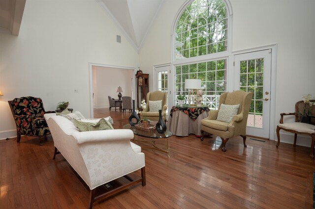 living room with dark hardwood / wood-style floors and high vaulted ceiling