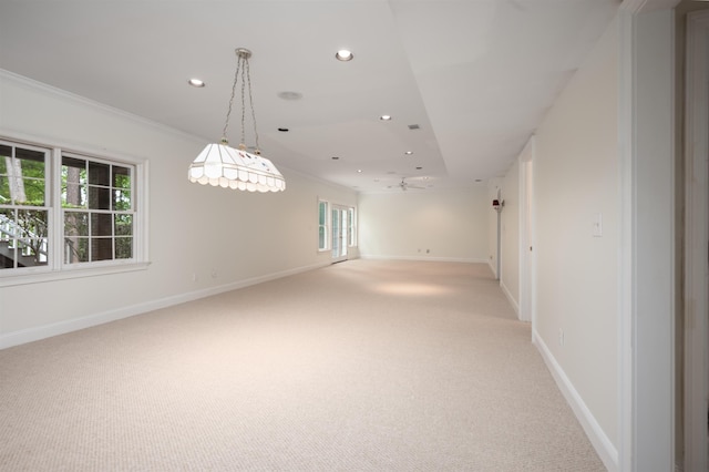 carpeted spare room featuring crown molding