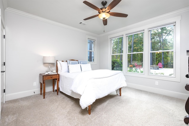 bedroom featuring crown molding, light colored carpet, ceiling fan, and multiple windows