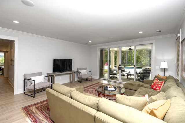 living room featuring crown molding and light wood-type flooring