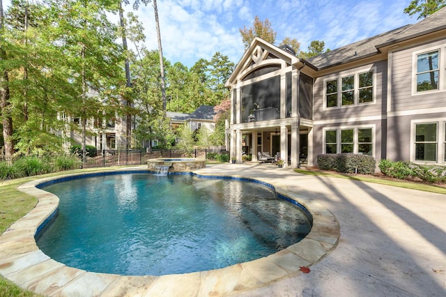 view of swimming pool with an in ground hot tub, a sunroom, and a patio