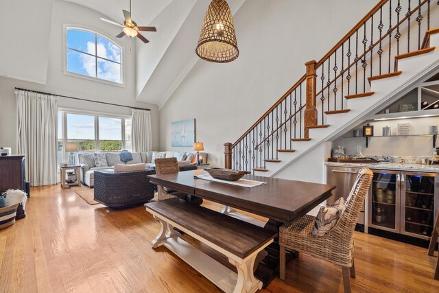 120UNIT304 Indian Summer Path, Eatonton, GA 31024 - dining room featuring bar, light wood-type flooring, ceiling fan, a towering ceiling, and beverage cooler