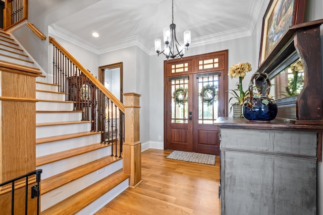 182 Corral Rd, Milledgeville, GA 31061 - foyer featuring a chandelier, stairway, wood finished floors, ornamental molding, and baseboards