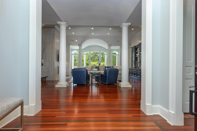 foyer featuring dark hardwood / wood-style flooring and ornate columns