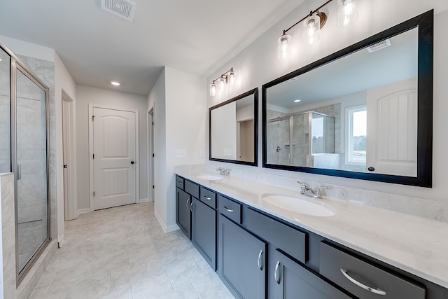 bathroom with vanity and a shower with shower door