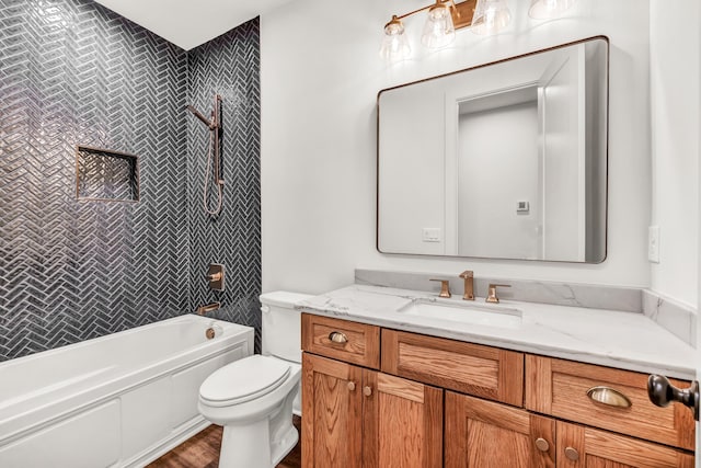 bathroom featuring toilet, vanity, wood finished floors, and tub / shower combination