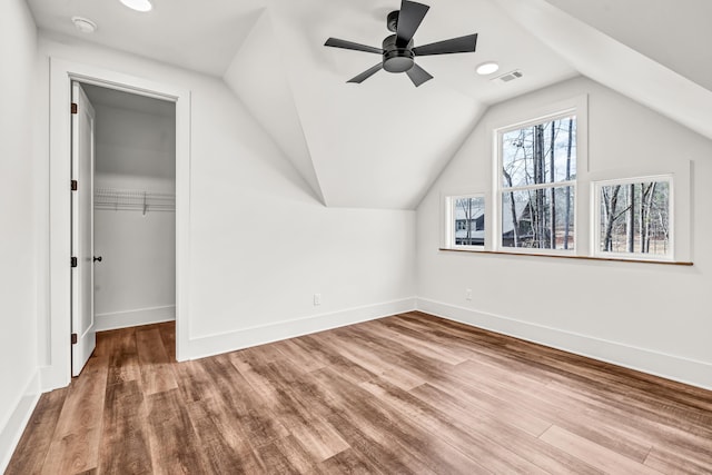 bonus room featuring wood finished floors, ceiling fan, vaulted ceiling, baseboards, and recessed lighting