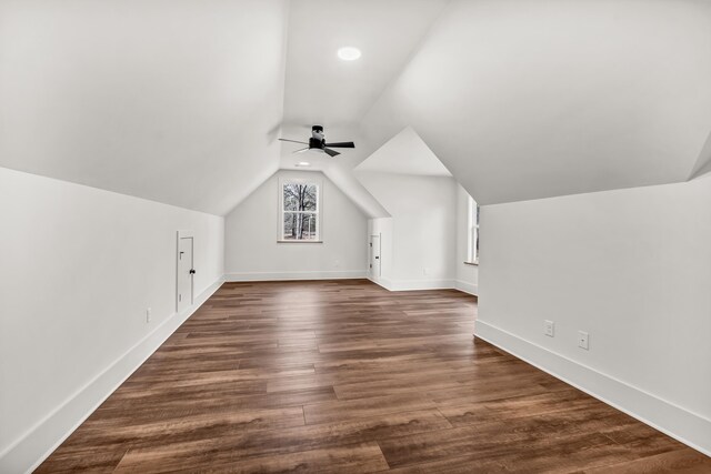 additional living space featuring vaulted ceiling, ceiling fan, baseboards, and dark wood finished floors