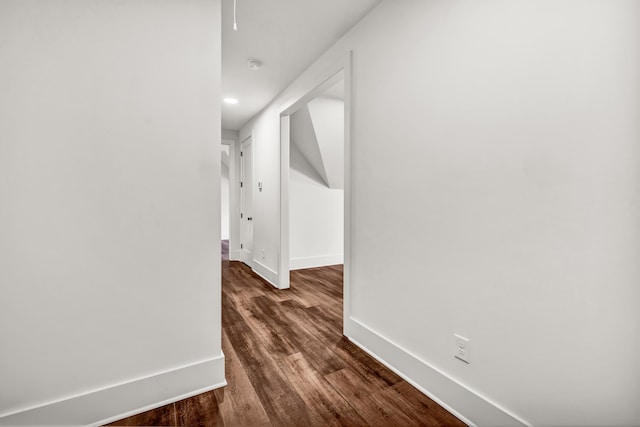 hallway featuring baseboards, dark wood-style floors, and recessed lighting
