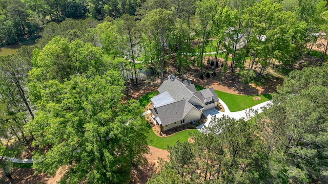 aerial view of property and surrounding area featuring a forest