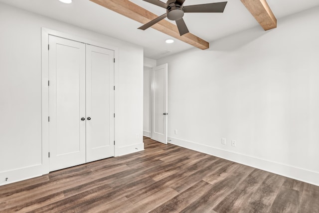unfurnished bedroom featuring beam ceiling, wood finished floors, recessed lighting, baseboards, and a closet