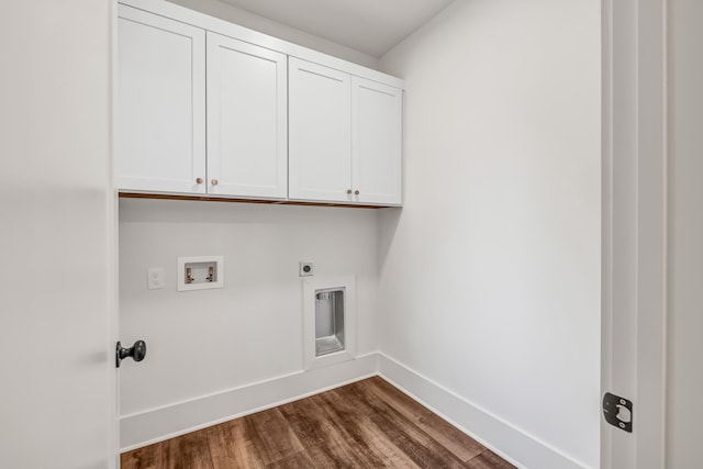 clothes washing area with cabinet space, electric dryer hookup, hookup for a washing machine, dark wood finished floors, and baseboards