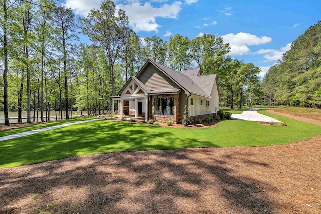 view of front of house with stone siding and a front yard