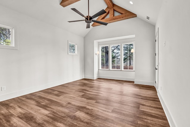 empty room featuring wood finished floors, a ceiling fan, and baseboards