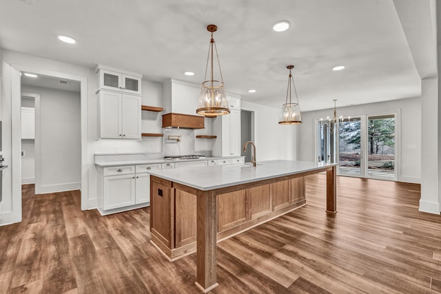 kitchen with light countertops, baseboards, dark wood-type flooring, white cabinetry, and recessed lighting