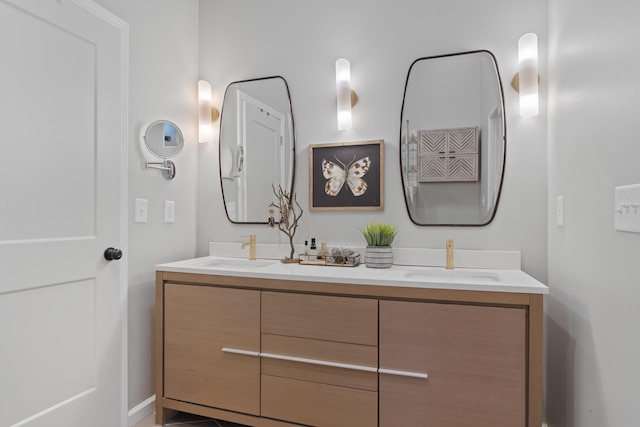 full bathroom with double vanity and a sink