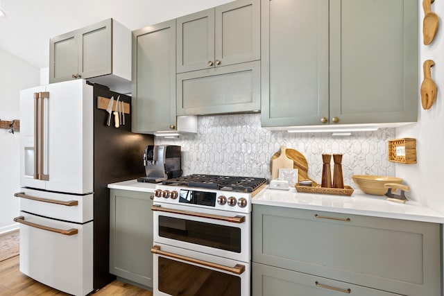 kitchen featuring light wood-style flooring, high quality appliances, extractor fan, and backsplash