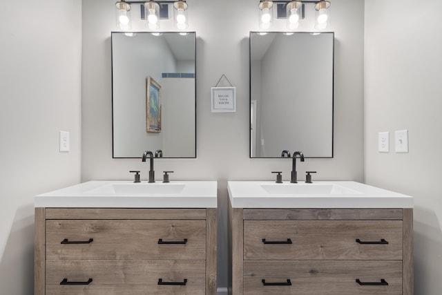 bathroom featuring two vanities and a sink