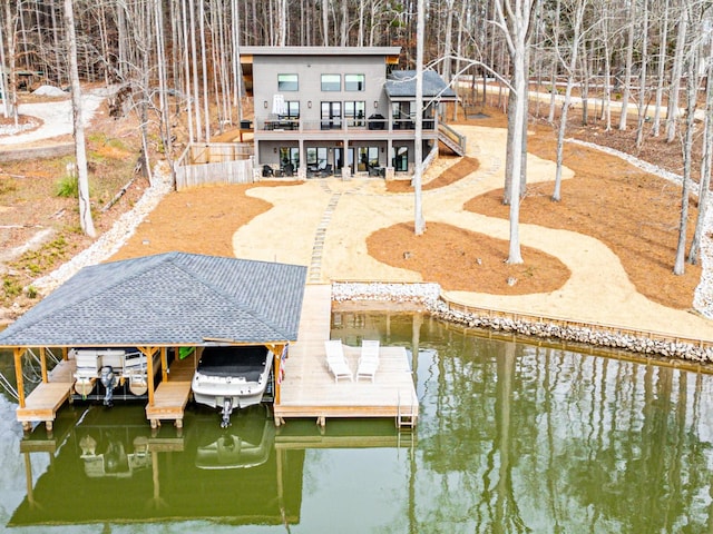 dock area with a water view and boat lift