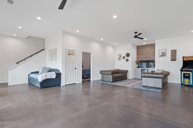 living area with finished concrete floors, baseboards, a ceiling fan, and recessed lighting