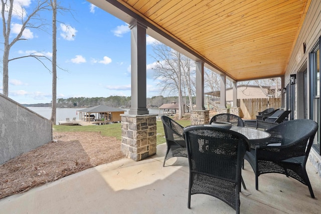 sunroom with a water view and wood ceiling