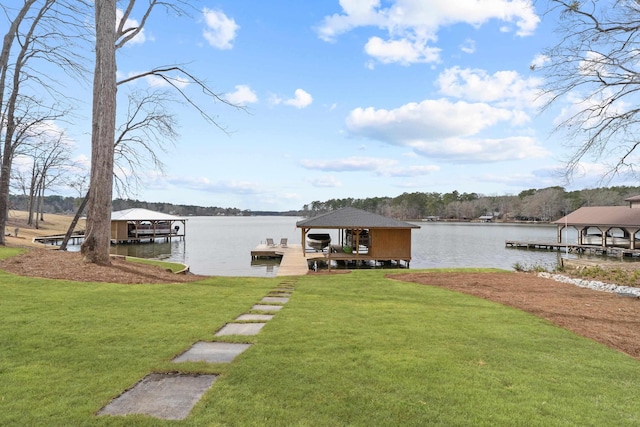 view of dock with a lawn, a water view, and boat lift