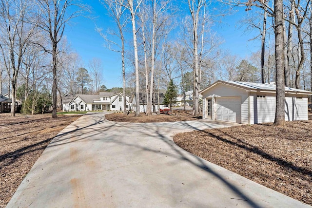 136 Hidden Lake Dr, Eatonton, GA 31024 - view of front of property featuring a garage, concrete driveway, and an outdoor structure