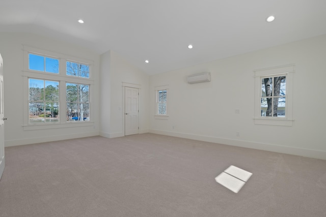 136 Hidden Lake Dr, Eatonton, GA 31024 - unfurnished room with plenty of natural light, light colored carpet, vaulted ceiling, and a wall mounted air conditioner