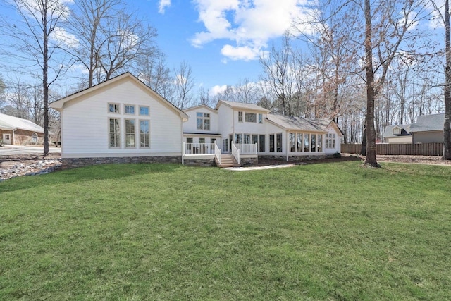 136 Hidden Lake Dr, Eatonton, GA 31024 - rear view of house with a lawn, fence, and a wooden deck