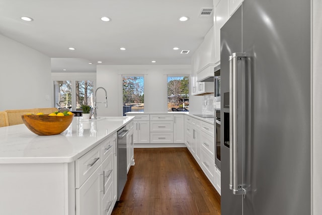 136 Hidden Lake Dr, Eatonton, GA 31024 - kitchen with visible vents, custom range hood, dark wood-style flooring, high end fridge, and a sink