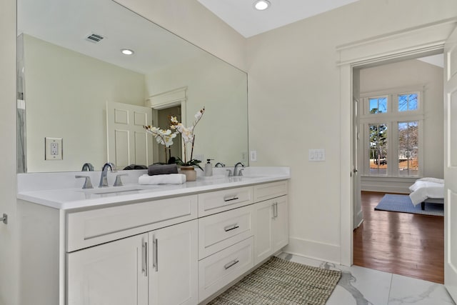 136 Hidden Lake Dr, Eatonton, GA 31024 - ensuite bathroom with marble finish floor, a sink, visible vents, and baseboards