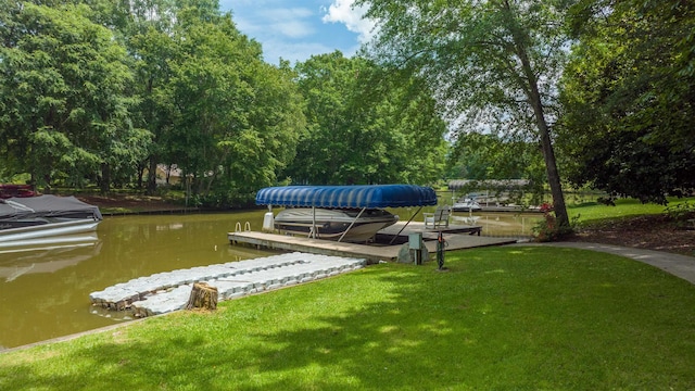 view of dock with a water view and a yard